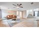 Bright living room features modern ceiling fan, neutral paint, stylish decor and carpeted stairs at 9328 Jumpin Juniper Ave, Las Vegas, NV 89129