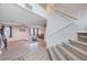 Bright living room features modern ceiling fan, neutral paint, stylish decor and carpeted stairs at 9328 Jumpin Juniper Ave, Las Vegas, NV 89129