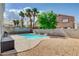 Inviting backyard pool area featuring desert landscaping and an attractive privacy wall at 9328 Jumpin Juniper Ave, Las Vegas, NV 89129