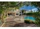 Expansive backyard featuring a pool, patio, and lush greenery, ideal for outdoor living and entertaining at 9772 Galahad Point Ct, Las Vegas, NV 89147