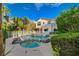 Lush backyard featuring a pool and spa, framed by mature trees and the home's inviting exterior at 9772 Galahad Point Ct, Las Vegas, NV 89147