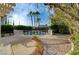 Picturesque backyard featuring a fenced pool, lush landscaping, and a charming brick walkway at 9772 Galahad Point Ct, Las Vegas, NV 89147