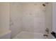 Modern bathroom shower with marble tile surround and new fixtures at 9772 Galahad Point Ct, Las Vegas, NV 89147