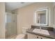 Contemporary bathroom with sleek vanity, backlit mirror, and glass-enclosed shower at 9772 Galahad Point Ct, Las Vegas, NV 89147