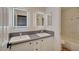 Bathroom with dual sinks and LED vanity mirrors at 9772 Galahad Point Ct, Las Vegas, NV 89147