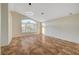 Large bedroom with vaulted ceiling, big window, and tile flooring at 9772 Galahad Point Ct, Las Vegas, NV 89147