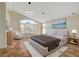 Main bedroom suite with large window and decorative painting at 9772 Galahad Point Ct, Las Vegas, NV 89147