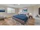 This staged bedroom features a queen bed, area rug, window view, and neutral tones at 9772 Galahad Point Ct, Las Vegas, NV 89147