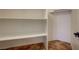 Walk-in closet with custom shelving and tiled flooring at 9772 Galahad Point Ct, Las Vegas, NV 89147