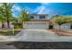 Charming two-story home with a three-car garage and desert landscaping at 9772 Galahad Point Ct, Las Vegas, NV 89147