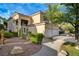Lush landscaping and a stucco exterior define this elegant home at 9772 Galahad Point Ct, Las Vegas, NV 89147