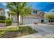 Landscaped front yard with a view of the three-car garage at 9772 Galahad Point Ct, Las Vegas, NV 89147
