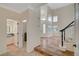 Inviting foyer with staircase and entry to bathroom and laundry room at 9772 Galahad Point Ct, Las Vegas, NV 89147