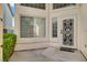 Covered entry featuring a modern door with decorative ironwork and sidelights at 9772 Galahad Point Ct, Las Vegas, NV 89147