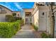 Pathway leading to the front door lined with lush greenery and decorative rocks at 9772 Galahad Point Ct, Las Vegas, NV 89147