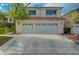 Exterior view showcasing a three-car garage with decorative windows at 9772 Galahad Point Ct, Las Vegas, NV 89147