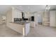 Bright kitchen with stainless steel appliances, gray countertops, and white cabinets at 9772 Galahad Point Ct, Las Vegas, NV 89147