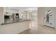 Modern kitchen with gray countertops, white cabinets, and stainless steel appliances at 9772 Galahad Point Ct, Las Vegas, NV 89147