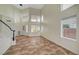 Bright living room with high ceilings, a staircase and tile flooring at 9772 Galahad Point Ct, Las Vegas, NV 89147
