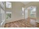 Spacious living room with high ceilings, many windows, and beautiful tile flooring at 9772 Galahad Point Ct, Las Vegas, NV 89147