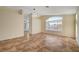 Bright living room featuring tile flooring, vaulted ceiling, and large windows at 9772 Galahad Point Ct, Las Vegas, NV 89147