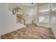 Bright living area with stairs to upper level, tile flooring and many windows at 9772 Galahad Point Ct, Las Vegas, NV 89147