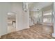 Bright living room featuring tile flooring and arched entryway into another living space at 9772 Galahad Point Ct, Las Vegas, NV 89147