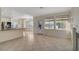 Bright open living room with tile flooring, and natural light with easy access to kitchen at 9772 Galahad Point Ct, Las Vegas, NV 89147