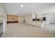 Bright living room with kitchen area, tile floors, stone wall feature, and fireplace at 9772 Galahad Point Ct, Las Vegas, NV 89147