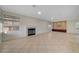 Cozy living room featuring a fireplace, neutral walls and tile flooring at 9772 Galahad Point Ct, Las Vegas, NV 89147
