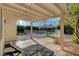 Relaxing covered patio with a view of the fenced pool and landscaped backyard, perfect for outdoor living at 9772 Galahad Point Ct, Las Vegas, NV 89147