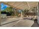 Covered patio with outdoor lounge area and landscaping at 9772 Galahad Point Ct, Las Vegas, NV 89147