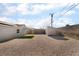 Wide view of the backyard with a storage shed and gravel landscaping at 113 Elm St, Henderson, NV 89015