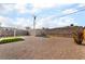 Large backyard with a storage shed, gravel ground cover, and partial shade cover at 113 Elm St, Henderson, NV 89015