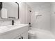 Contemporary bathroom with a white vanity, black fixtures, and a shower with marble-look tile at 113 Elm St, Henderson, NV 89015