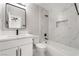 Modern bathroom with marble tiled shower, black fixtures, and a sleek vanity at 113 Elm St, Henderson, NV 89015