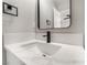 Bathroom vanity featuring a white marble countertop, modern faucet, and a sleek mirror at 113 Elm St, Henderson, NV 89015