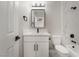 Modern bathroom featuring white vanity, sleek fixtures, and a shower with marble-look tile at 113 Elm St, Henderson, NV 89015