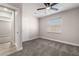 Neutral bedroom showcasing plush carpet, ceiling fan, and adjoining doors to other rooms at 113 Elm St, Henderson, NV 89015