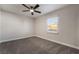 Bright bedroom with gray carpet, a ceiling fan, and a window with natural light at 113 Elm St, Henderson, NV 89015