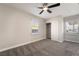Bedroom featuring neutral walls, gray carpeting, ceiling fan, and closet with sliding doors at 113 Elm St, Henderson, NV 89015