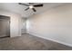 Expansive bedroom with gray carpet, neutral walls, ceiling fan, and a spacious closet at 113 Elm St, Henderson, NV 89015