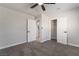 Spacious bedroom with gray carpeting, closet and bathroom access, and a modern ceiling fan at 113 Elm St, Henderson, NV 89015