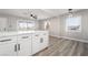 Bright dining area with island, white cabinets, modern lighting, and views through the window at 113 Elm St, Henderson, NV 89015