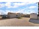 House exterior featuring a gravel backyard with a shed and partial shade, plus solar panels at 113 Elm St, Henderson, NV 89015