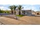 Gray single-story home with desert landscaping, palm trees, and an extended, covered front porch at 113 Elm St, Henderson, NV 89015