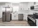 Renovated kitchen with stainless steel appliances and stylish white cabinets at 113 Elm St, Henderson, NV 89015