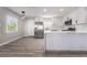 Modern kitchen featuring white cabinetry, stainless steel appliances, and a breakfast bar at 113 Elm St, Henderson, NV 89015