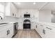 Modern kitchen featuring white cabinets, stainless steel appliances, and a stylish backsplash at 113 Elm St, Henderson, NV 89015