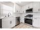 Well-lit kitchen showcasing white cabinets, stainless steel appliances, and light wood flooring at 113 Elm St, Henderson, NV 89015